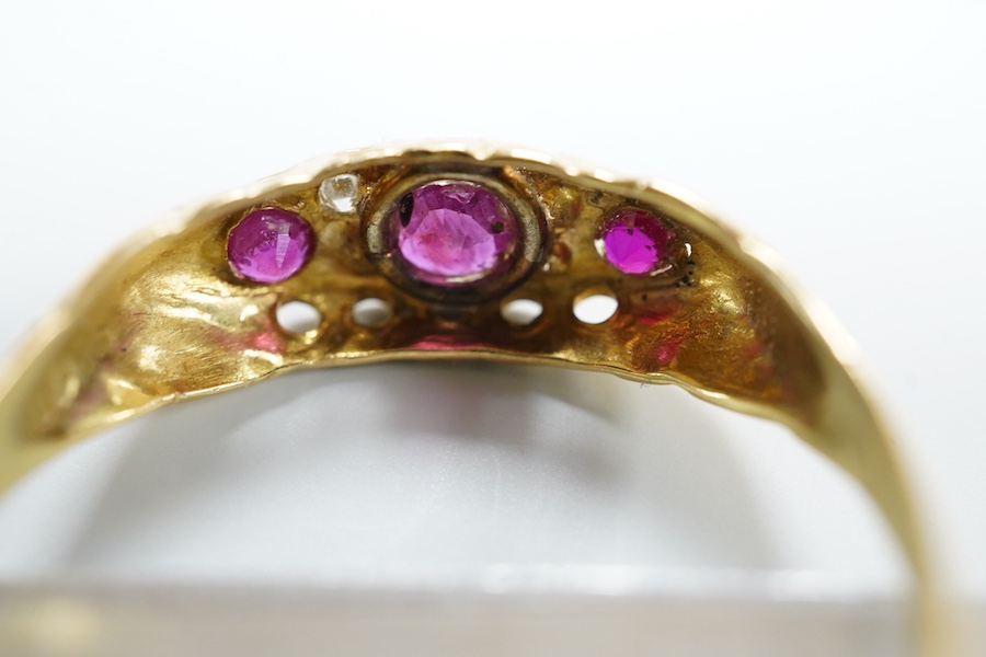 A ruby and diamond ring, circa 1916, set with three circular-cut rubies, spaced by pairs of circular-cut diamonds, mounted in 18ct gold, size R1/2, British hallmarks, gross weight approximately 2 grams, one ruby syntheti